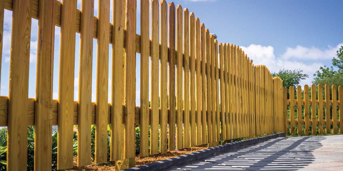A Wooden Fence Surrounding a Concrete Patio.